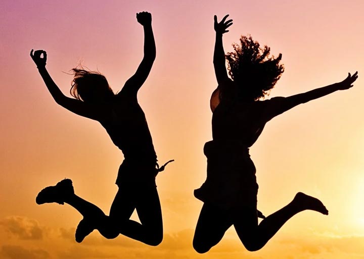 Picture showing two peope jumping for joy. Cheap web editing company.